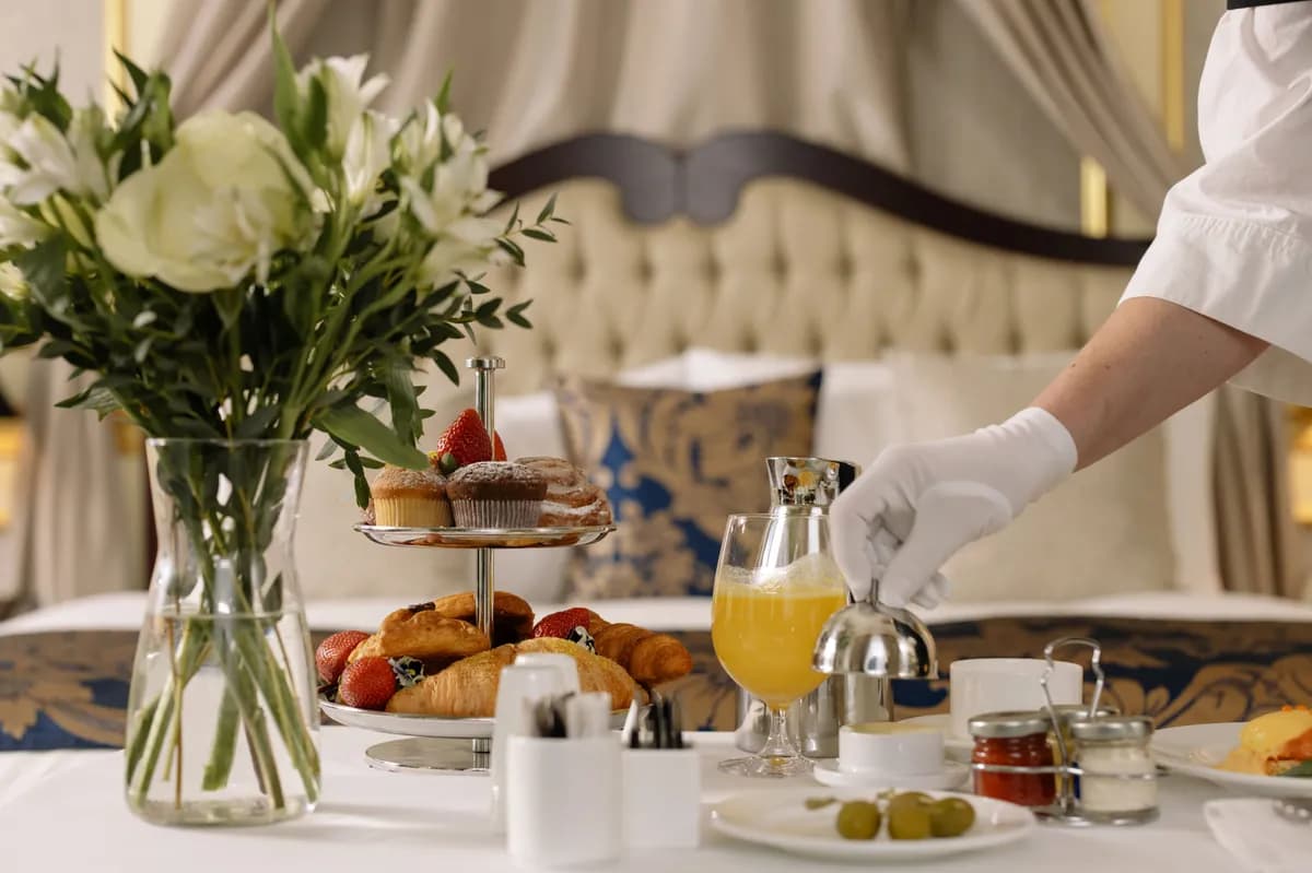 BookNoFees sample image: Breakfast table with pastries, flowers, and a glass of orange juice