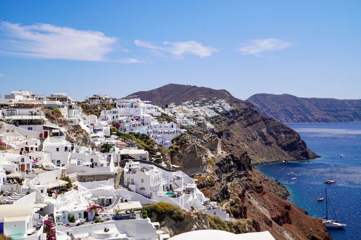 BookNoFees sample image: White houses overlooking the sea on a steep Cycladic hillside