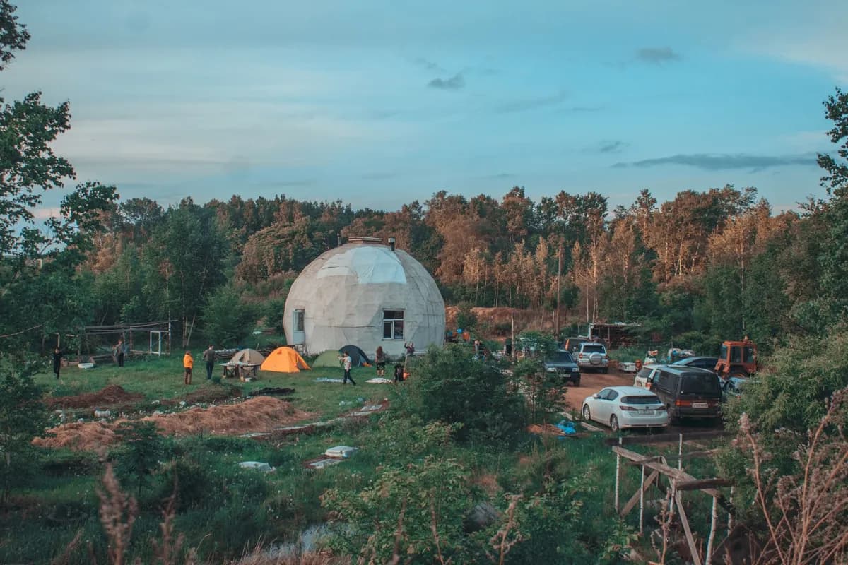 BookNoFees example image: Dome-shaped structures at a nature-oriented campground