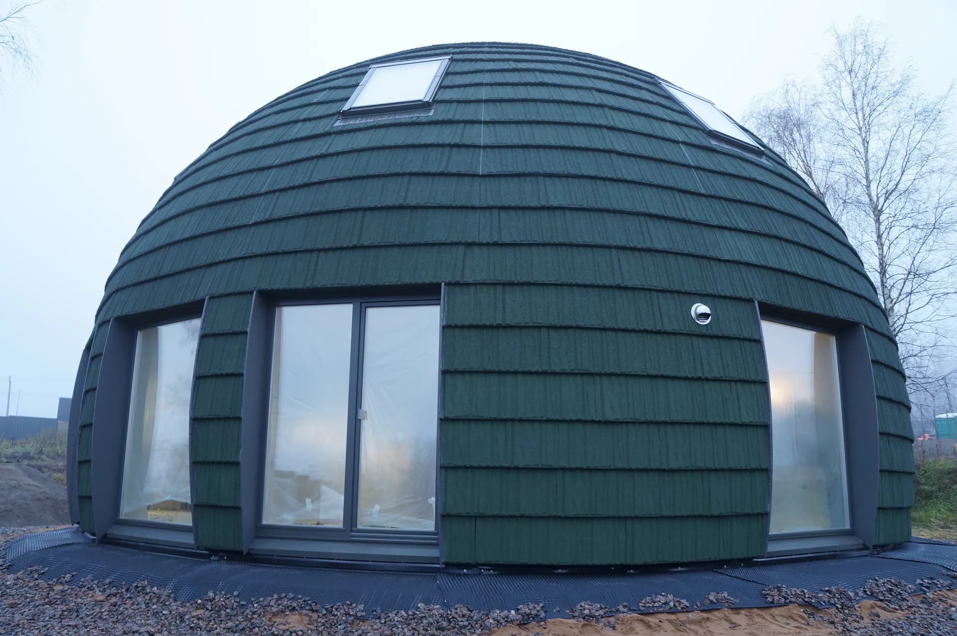BookNoFees example image: Green domed house with large windows and a triangular front door