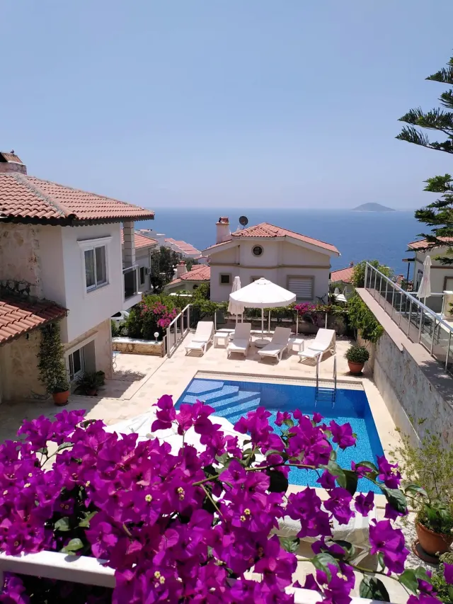 BookNoFees vacation rental in Kalkan, Kas, Antalya, Antalya, Turkey – Terrace with swimming pool, sun loungers, umbrella, and sea view