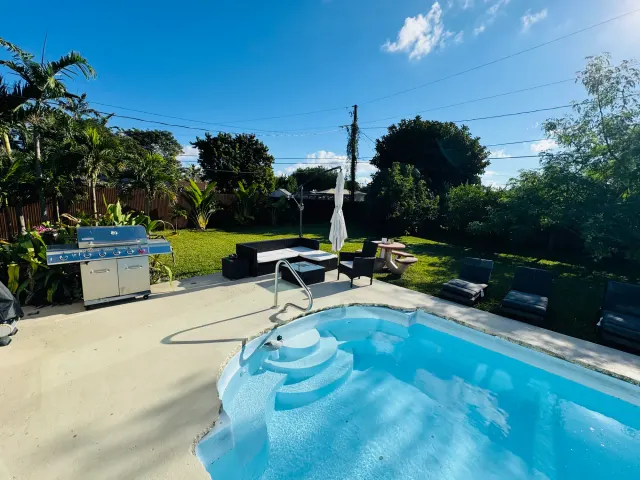 BookNoFees vacation rental in Cutler Bay – Backyard with swimming pool, grill, and patio furniture
